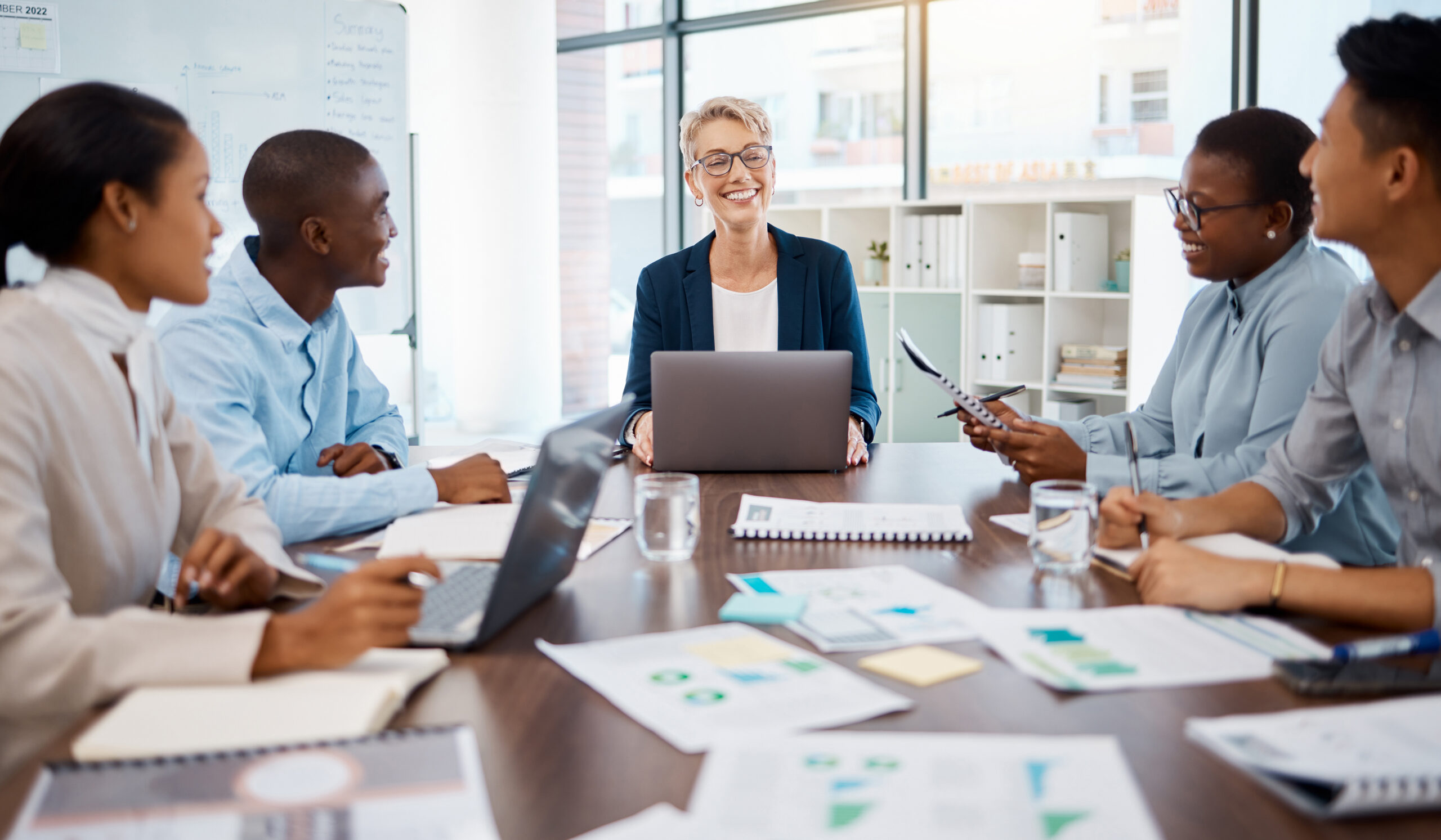 diverse team of professionals work at a table on marketing strategy